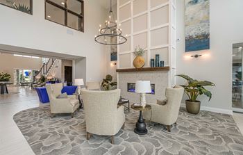a living room with couches and chairs and a fireplace